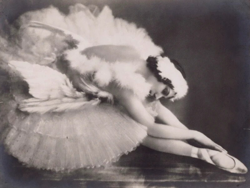 Anna Pavlova performing The Dying Swan, captured in a moment of expressive, feather-like movement