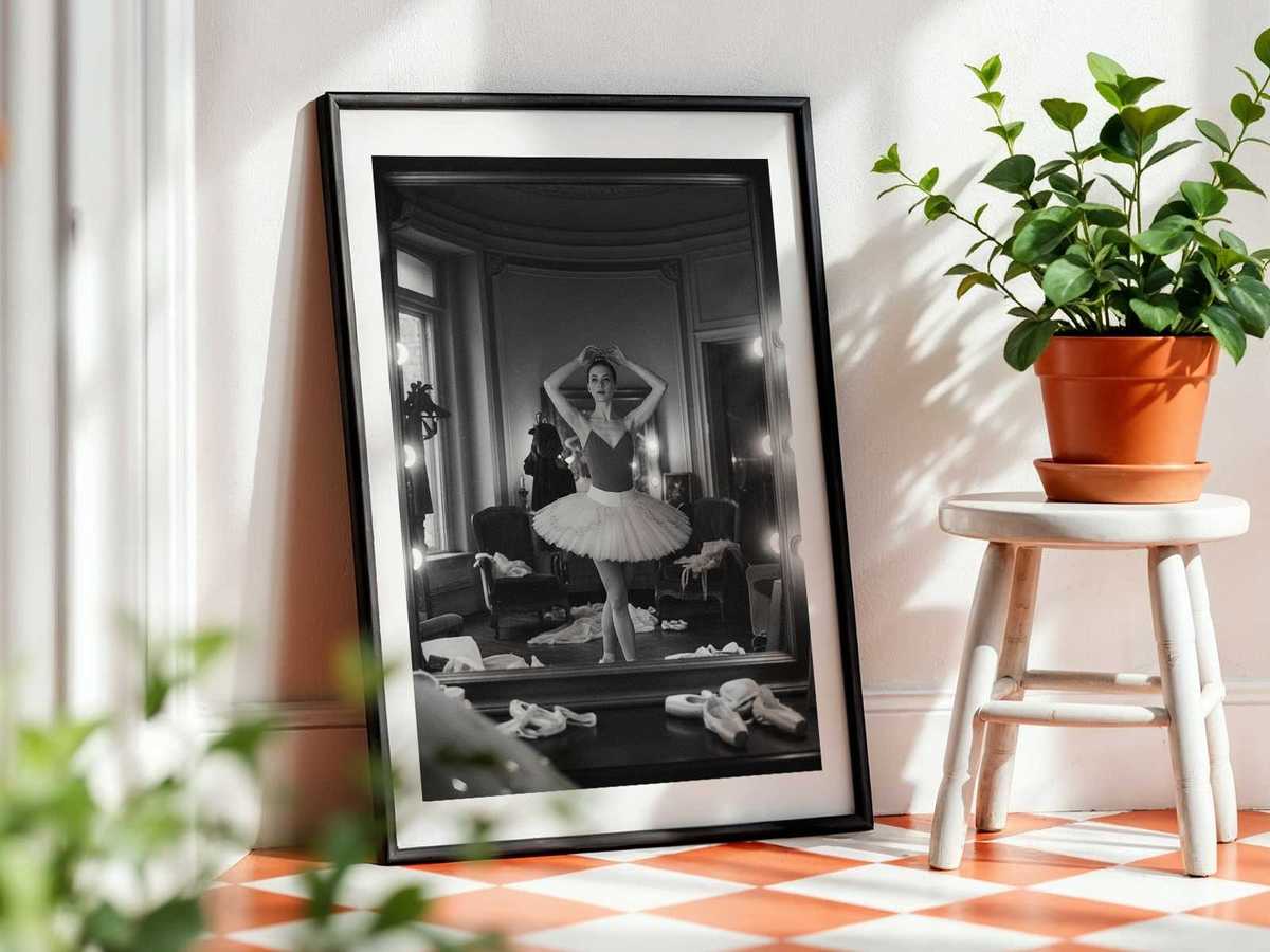 Dancer holding an attitude before a mirror, the reflected limb creating a layered depth of line