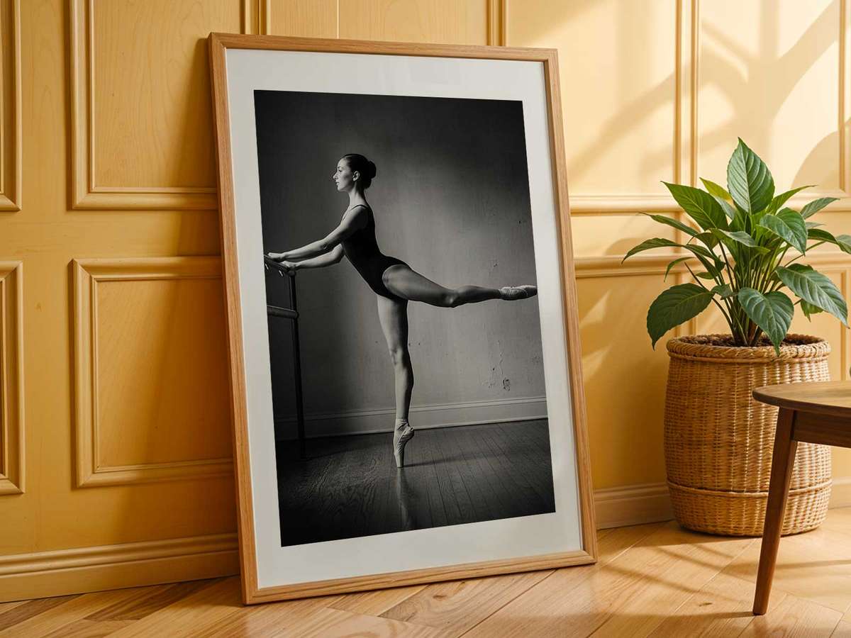 Close view of a dancer’s foot resting on the barre while the body balances, showing tension and elegance in practice