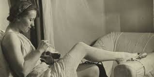 Galina Ulanova performing an arabesque on a bare stage, showing a clean line from fingertips to toe and serene facial…