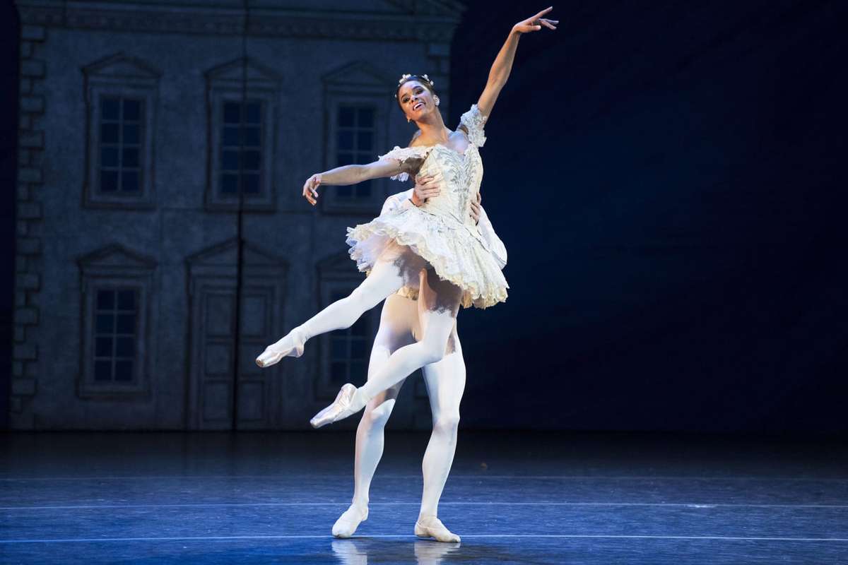 Misty Copeland during rehearsal receiving corrections from a coach while repeating a precise foot and arm sequence