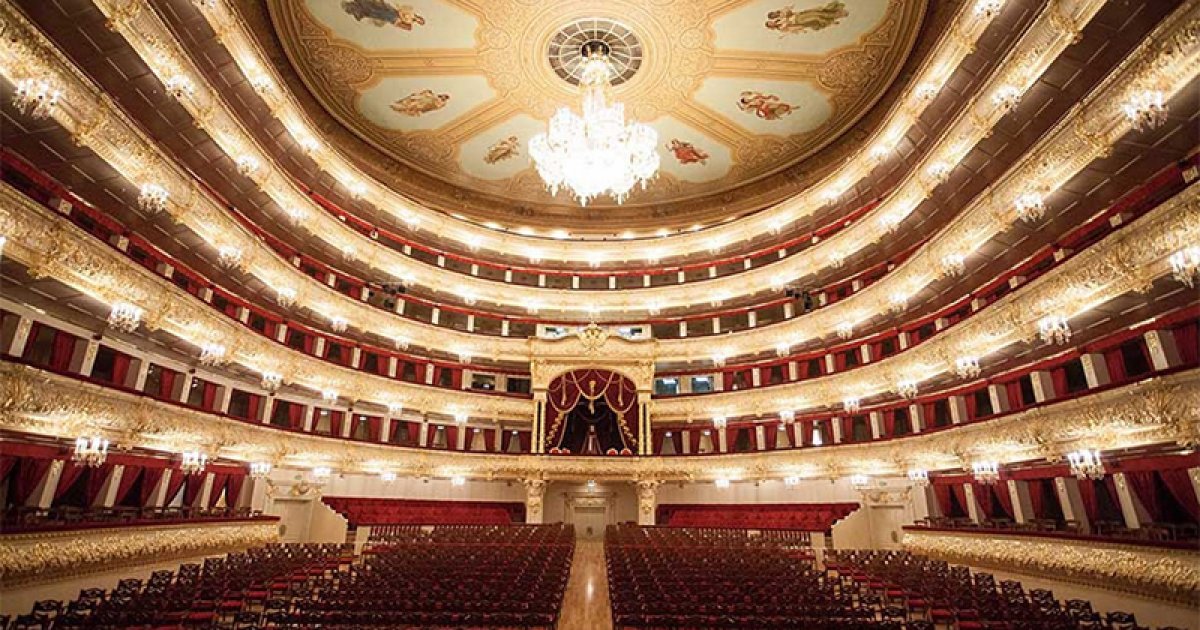 Bolshoi Ballet dancers rehearsing on the main stage with set pieces and coaches observing