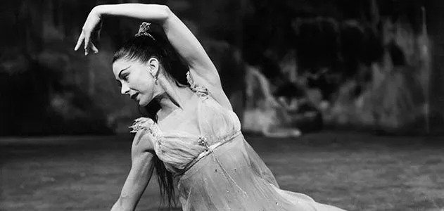 Close-up of Dame Margot's expressive hands and upper body as she shapes a musical phrase in performance