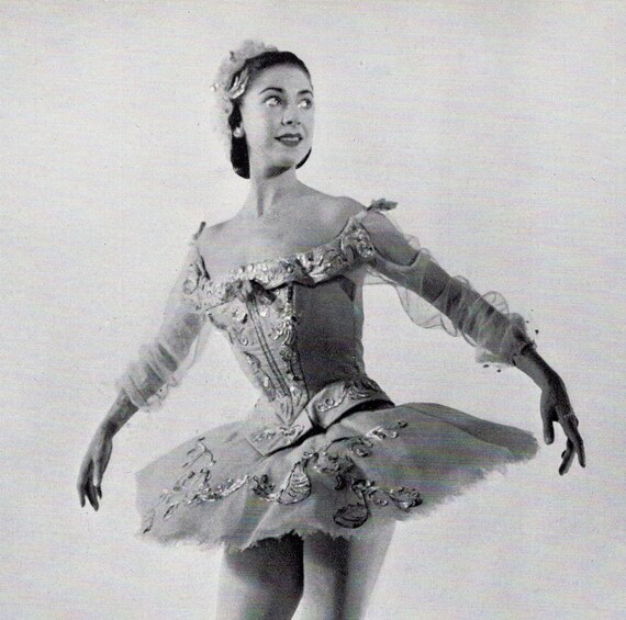 Margot Fonteyn in a classical tutu, poised in a graceful arabesque on stage