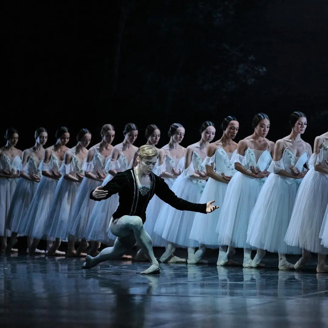 Giselle collapsing in a dramatic moment of madness as her grief and betrayal overwhelm her on stage