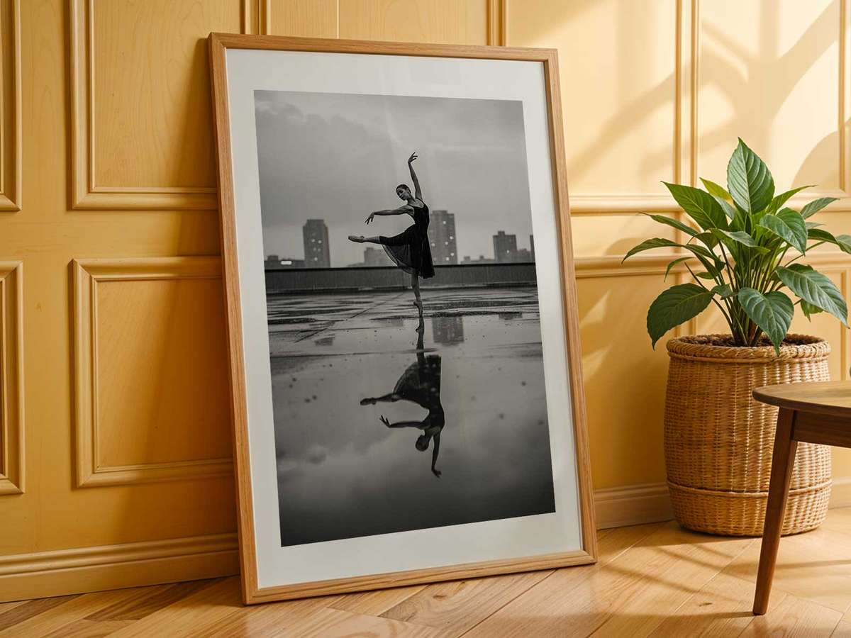 Minimalist poster of a ballerina against a broad, empty urban facade, emphasizing shape, line, and poised head
