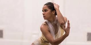 Misty Copeland mid-rehearsal concentrating at the barre, preparing a solo with focused expression