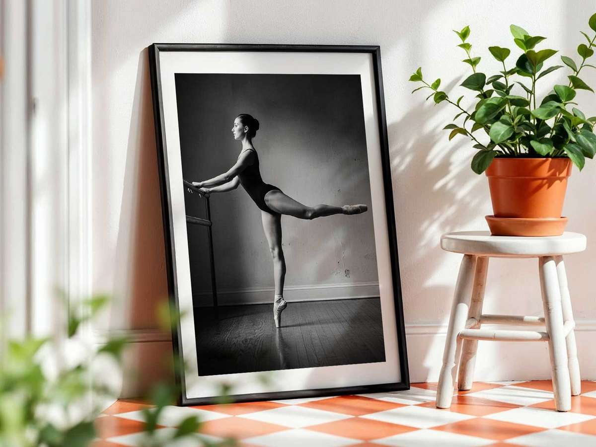 Dancer mid-stretch on the floor, expressing the measured calm of preparation and the simplicity of the studio environment