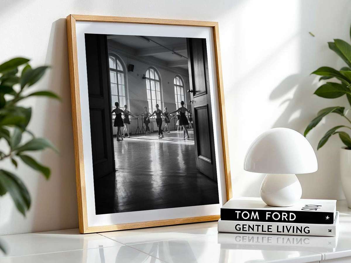 Ballet dancer at the barre reflected in the mirror, a suspended moment of focus and sculpted line