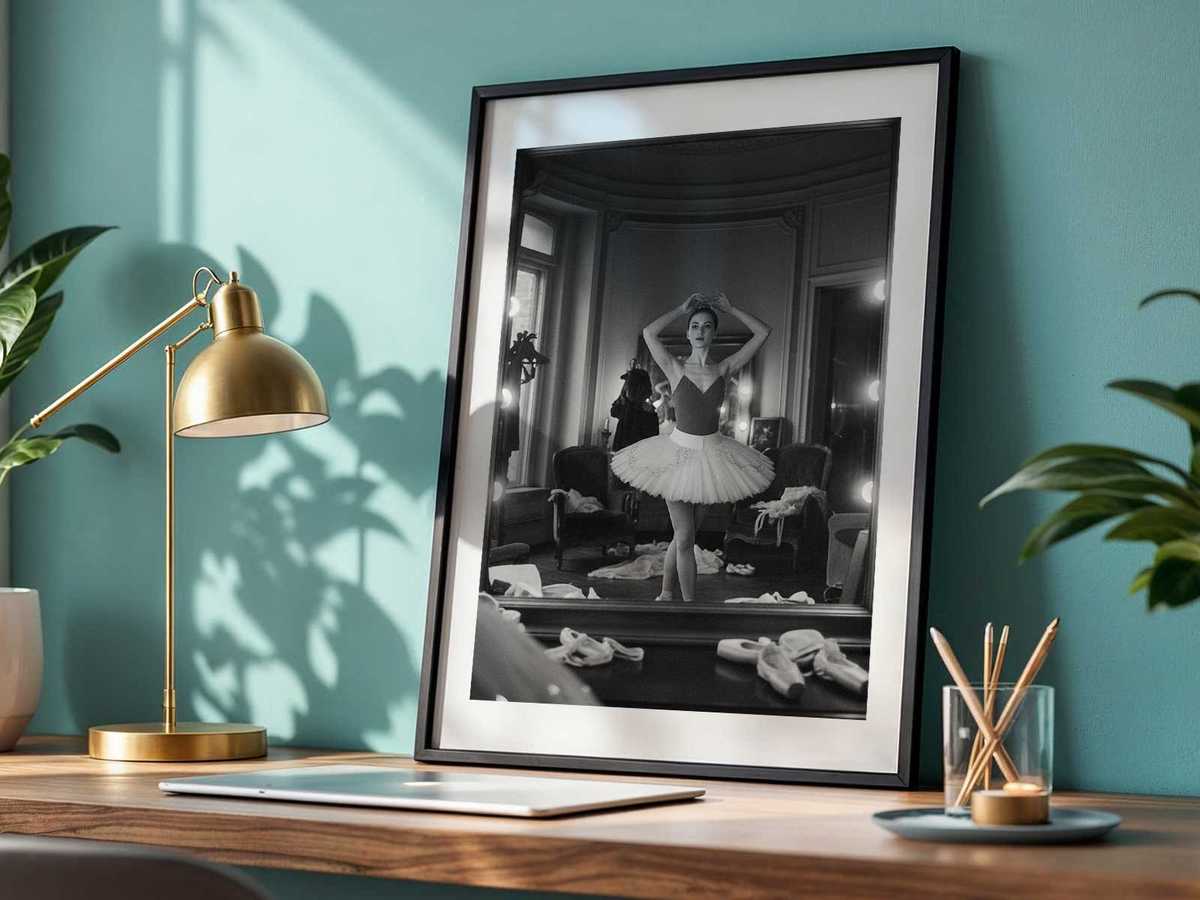 Close-up of a ballerina's concentrated expression and poised arm reflected in a rehearsal mirror
