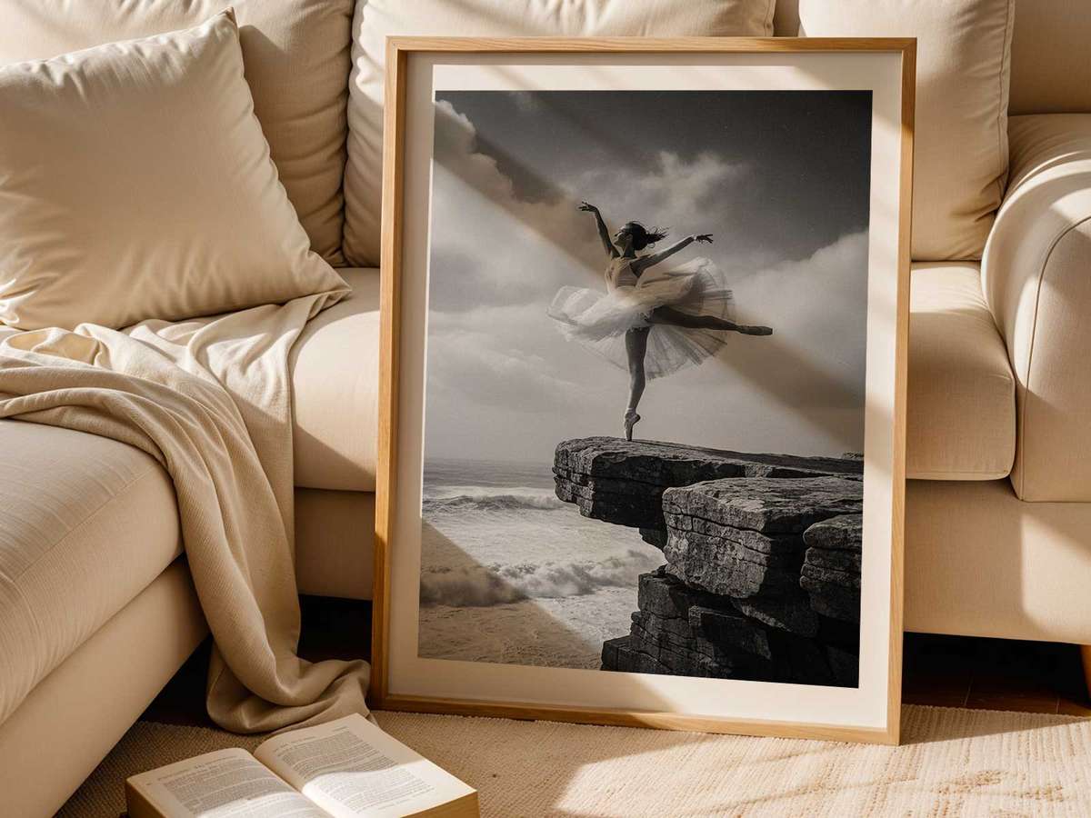 Dancer en pointe framed by a natural sea arch, rock formation providing a dramatic architectural backdrop