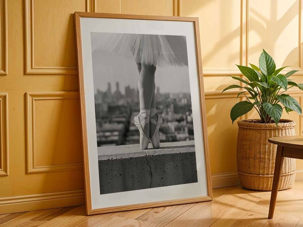 Close-up of a ballerina on pointe with soft shadows, showcasing the stretched silhouette and the texture of the costume