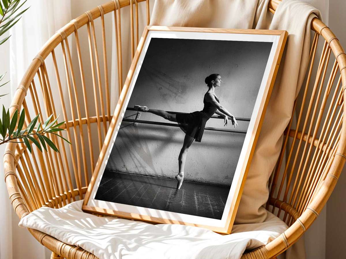 Full-length view of a ballet dancer reaching upward with an elongated torso and poised balance in studio light