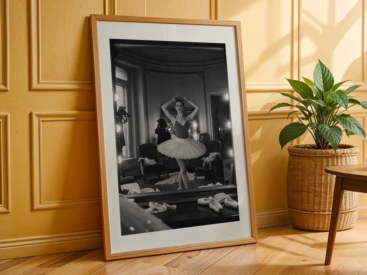 Ballet gesture illuminated by studio light, mirror doubling the delicate curve of the body