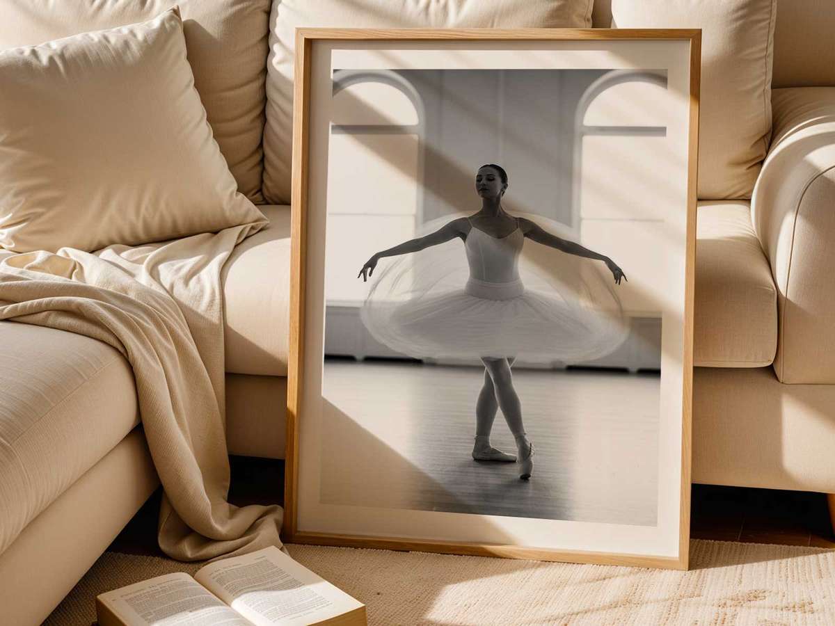 Silhouette of a dancer framed by a large studio window, the light defining the emerging contours of a gesture in progress