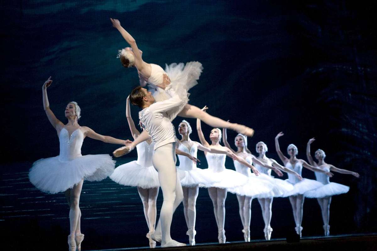 A ballerina mid-transformation with delicate arm extensions and a hint of feathered costume suggesting the metamorphosis…