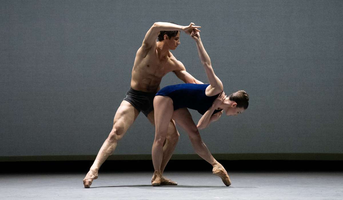 Tiler Peck demonstrating clear épaulement and clean lines against a neutral stage backdrop