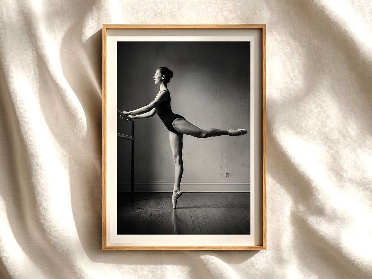Ballet dancer in profile silhouette at the barre, capturing quiet concentration and poised balance in a sunlit studio